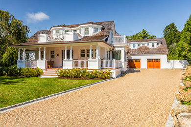 Inspiration for a coastal white two-story exterior home remodel in Boston with a shingle roof