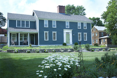 Inspiration for a large timeless blue two-story wood gable roof remodel in Boston