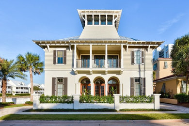 Beach style beige three-story exterior home photo in Jacksonville with a hip roof