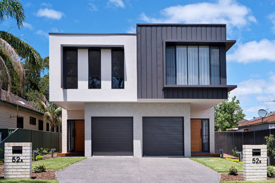 This is an example of a multi-coloured contemporary two floor semi-detached house in Sydney with mixed cladding and a flat roof.