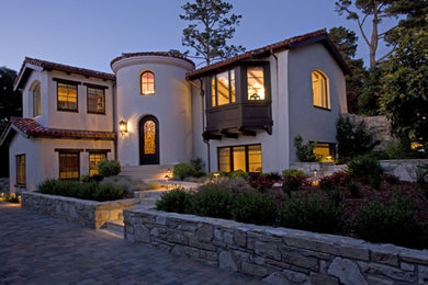 Large southwestern white two-story stucco exterior home idea in San Francisco with a tile roof