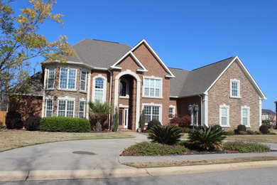 Example of a large classic brown two-story stone gable roof design in Atlanta