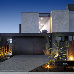Large contemporary two-storey concrete grey house exterior in Melbourne with a flat roof.