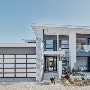This is an example of a contemporary two-storey grey house exterior in Gold Coast - Tweed with mixed siding and a flat roof.