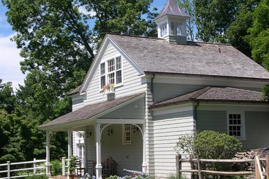 Mid-sized cottage white two-story vinyl gable roof idea in New York
