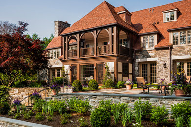 Large elegant three-story stone exterior home photo in Philadelphia