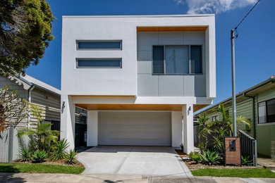 Modelo de fachada de casa blanca contemporánea pequeña de dos plantas con revestimiento de aglomerado de cemento, tejado plano y tejado de metal