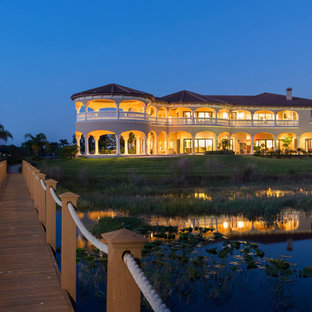 Inspiration for a huge mediterranean beige two-story stucco exterior home remodel in Orlando
