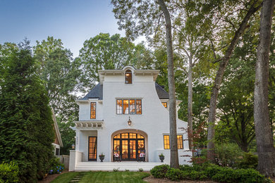 This is an example of a large and white traditional two floor house exterior in Charlotte with mixed cladding.