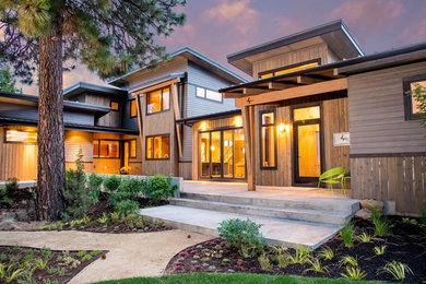 Photo of a medium sized and beige modern two floor house exterior in Seattle with wood cladding and a lean-to roof.