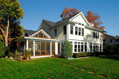 Example of a mid-sized classic yellow two-story mixed siding exterior home design in Minneapolis