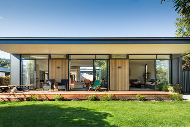 Photo of a contemporary bungalow house exterior in Christchurch with wood cladding.
