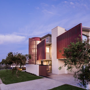Photo of a contemporary two-storey multi-coloured house exterior in Gold Coast - Tweed with mixed siding.