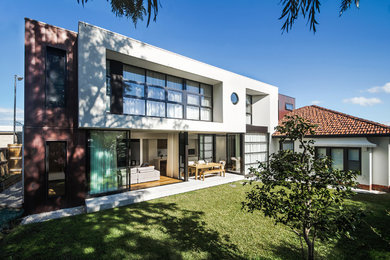 Mittelgroßes, Zweistöckiges Modernes Einfamilienhaus mit Metallfassade, weißer Fassadenfarbe, Flachdach und Blechdach in Melbourne