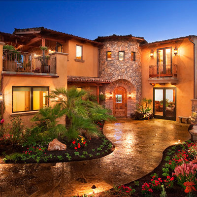 Mid-sized mediterranean brown two-story stucco gable roof idea in San Luis Obispo