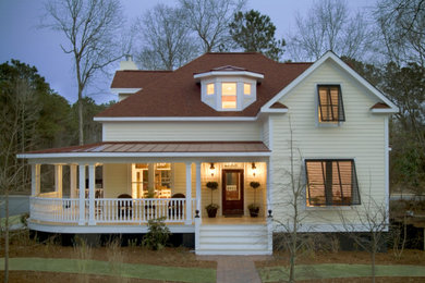 Inspiration for a mid-sized timeless yellow two-story vinyl exterior home remodel in Charleston with a shed roof