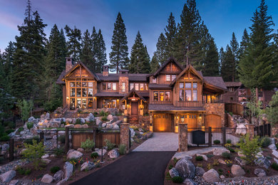 Inspiration for a large rustic brown three-story wood exterior home remodel in Other