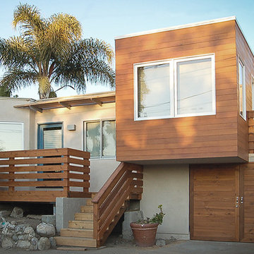 cedar-clad cantilever with flat roof