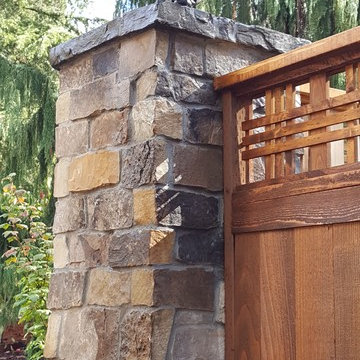 Cedar fence with stone columns and electric lanterns - before and after pictures