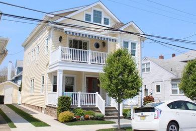 Mid-sized trendy three-story vinyl exterior home photo in Philadelphia with a shingle roof