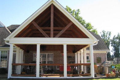 Inspiration for a rustic red one-story brick exterior home remodel in Other with a hip roof