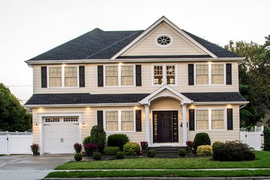 Large transitional white two-story concrete fiberboard exterior home idea in New York with a hip roof