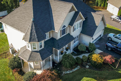 Inspiration for a large timeless two-story vinyl exterior home remodel in Other with a shingle roof
