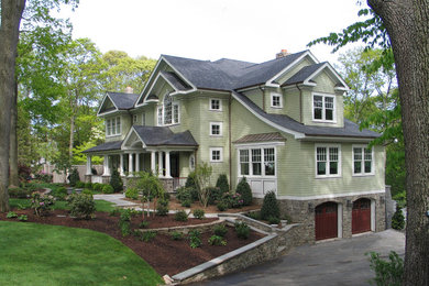 Large elegant green two-story wood gable roof photo in New York