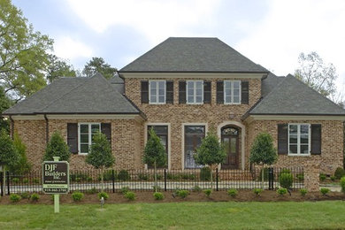 Elegant house exterior photo in Raleigh with a shingle roof