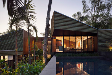 Design ideas for a brown modern house exterior in Brisbane with wood cladding.