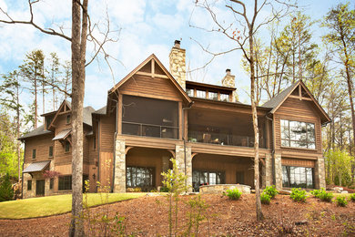 Mountain style yellow three-story wood exterior home photo in Other