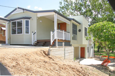 Photo of a large contemporary two floor detached house in Brisbane with mixed cladding.