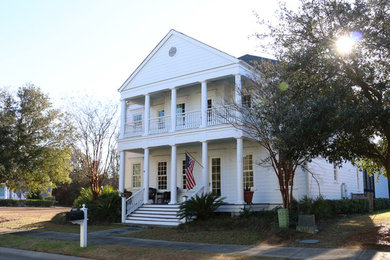 Inspiration for a large timeless white two-story concrete fiberboard exterior home remodel in Other with a shingle roof