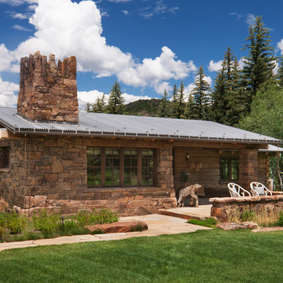 Inspiration for a rustic one-story mixed siding exterior home remodel in Other with a metal roof