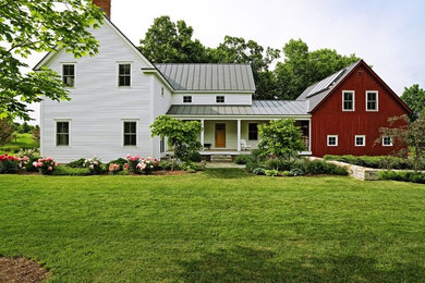 Mid-sized country multicolored two-story wood exterior home photo in Burlington with a metal roof