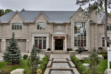 Inspiration for a timeless beige two-story stone exterior home remodel in Toronto