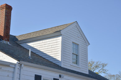 Traditional white two-story wood and shingle house exterior idea in Boston with a shingle roof and a black roof