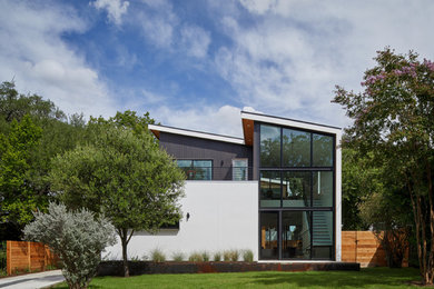 Inspiration for a large modern white two-story mixed siding house exterior remodel in Austin with a shed roof and a metal roof