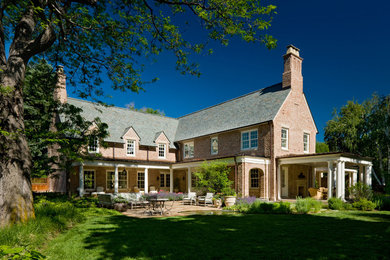 This is an example of a large traditional two floor brick house exterior in Denver.