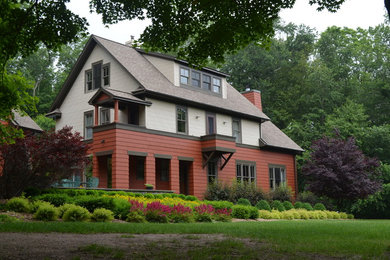 Mid-sized trendy multicolored three-story wood exterior home photo in Other with a shingle roof