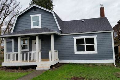 Mid-sized cottage blue two-story wood house exterior idea in Seattle with a gambrel roof and a shingle roof