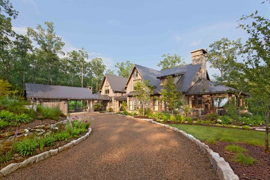 Inspiration for a large rustic two-story exterior home remodel in Other