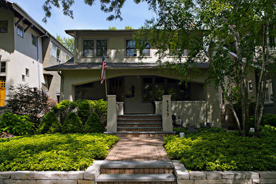 Example of a mid-sized transitional beige two-story stucco exterior home design in Chicago with a shed roof