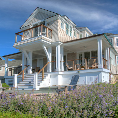 Example of a beach style two-story wood exterior home design in Bridgeport