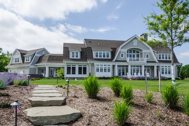 Huge transitional beige two-story wood exterior home photo in Baltimore with a gambrel roof