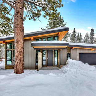 Example of a large trendy gray one-story metal house exterior design in Other with a shed roof