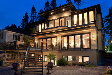 Inspiration for a mid-sized contemporary beige three-story mixed siding exterior home remodel in Vancouver