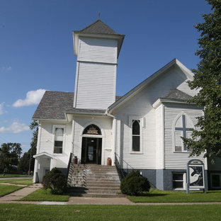 Example of a large mountain style white two-story wood exterior home design in Other with a gambrel roof