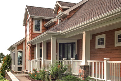 Diseño de fachada de casa marrón de estilo americano grande de dos plantas con revestimiento de madera, tejado a dos aguas y tejado de teja de madera