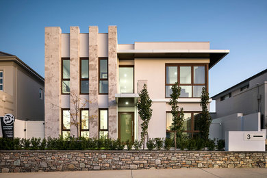 Design ideas for a medium sized and gey modern two floor house exterior in Perth with stone cladding.